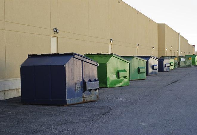 construction workers disposing of debris in large dumpsters in Caledonia, WI